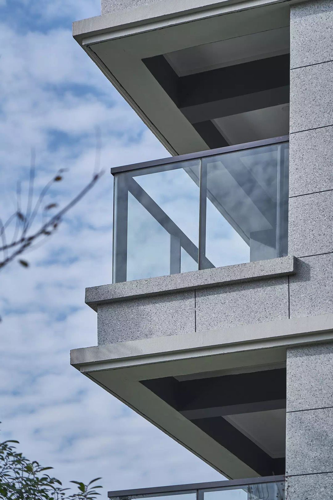 挺拔的高层,映衬天空蓝的low-e中空玻璃,玻璃栏板为主材的阳台栏杆.