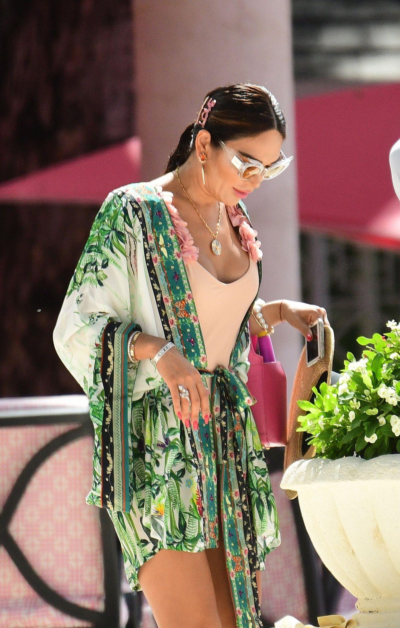 女星一袭粉色连体泳装亮相海滩度假,戴草帽拿手机拍照休闲惬意