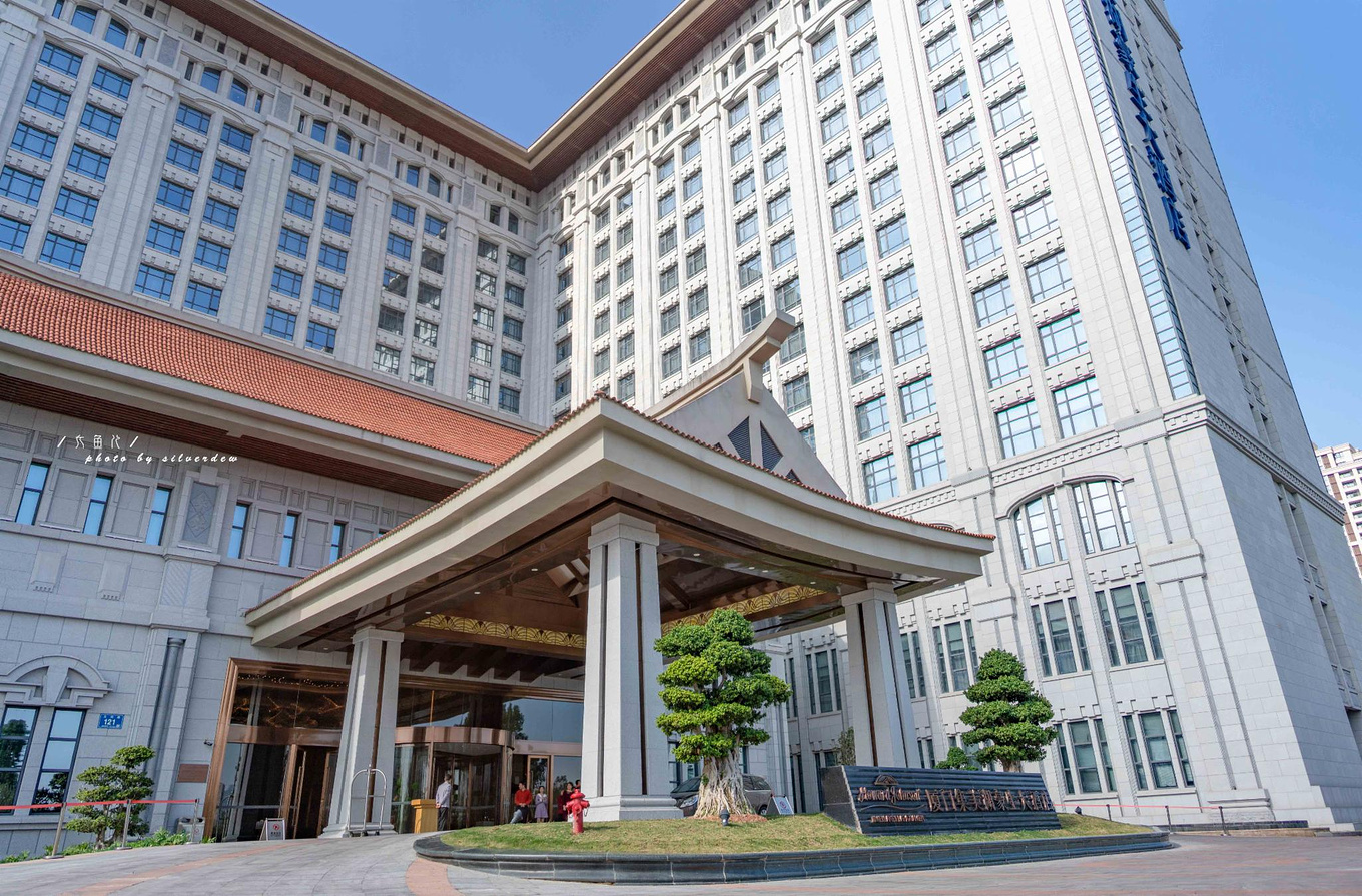 远望,厦门集美湖豪生酒店外观为红瓦飞檐闽南式屋顶与西洋式屋身中西