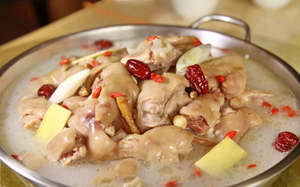 入清水并加姜块和葱节,待大火烧开后,改小火同炖至熟且汤汁鲜香浓白2