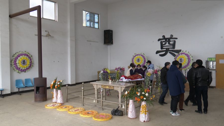 不搭灵棚,没有挽联,一柱香火,四提花篮,偌大的殡仪馆内简朴至极.