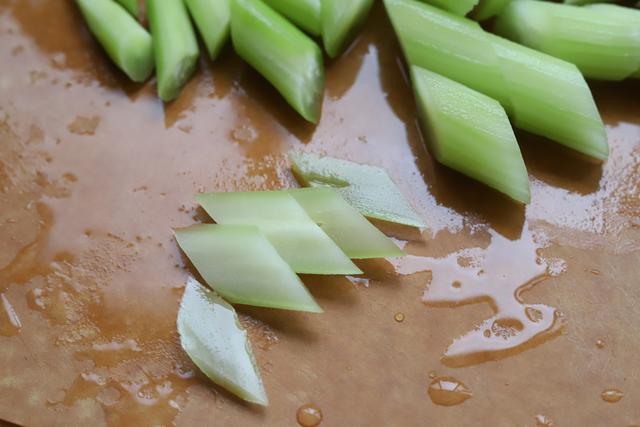 3,将每块莴笋竖起来,直直切成片,这样切出来的莴笋就成了漂亮的菱形片