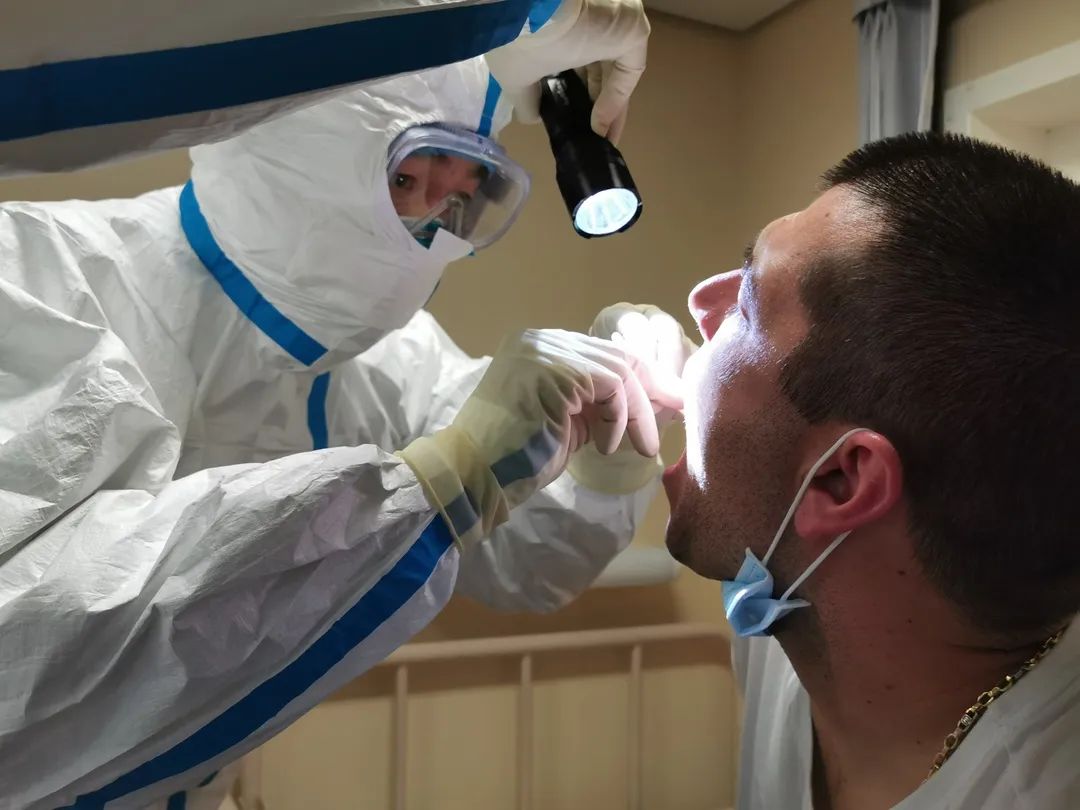 海关关员对入境人员进行咽部检查