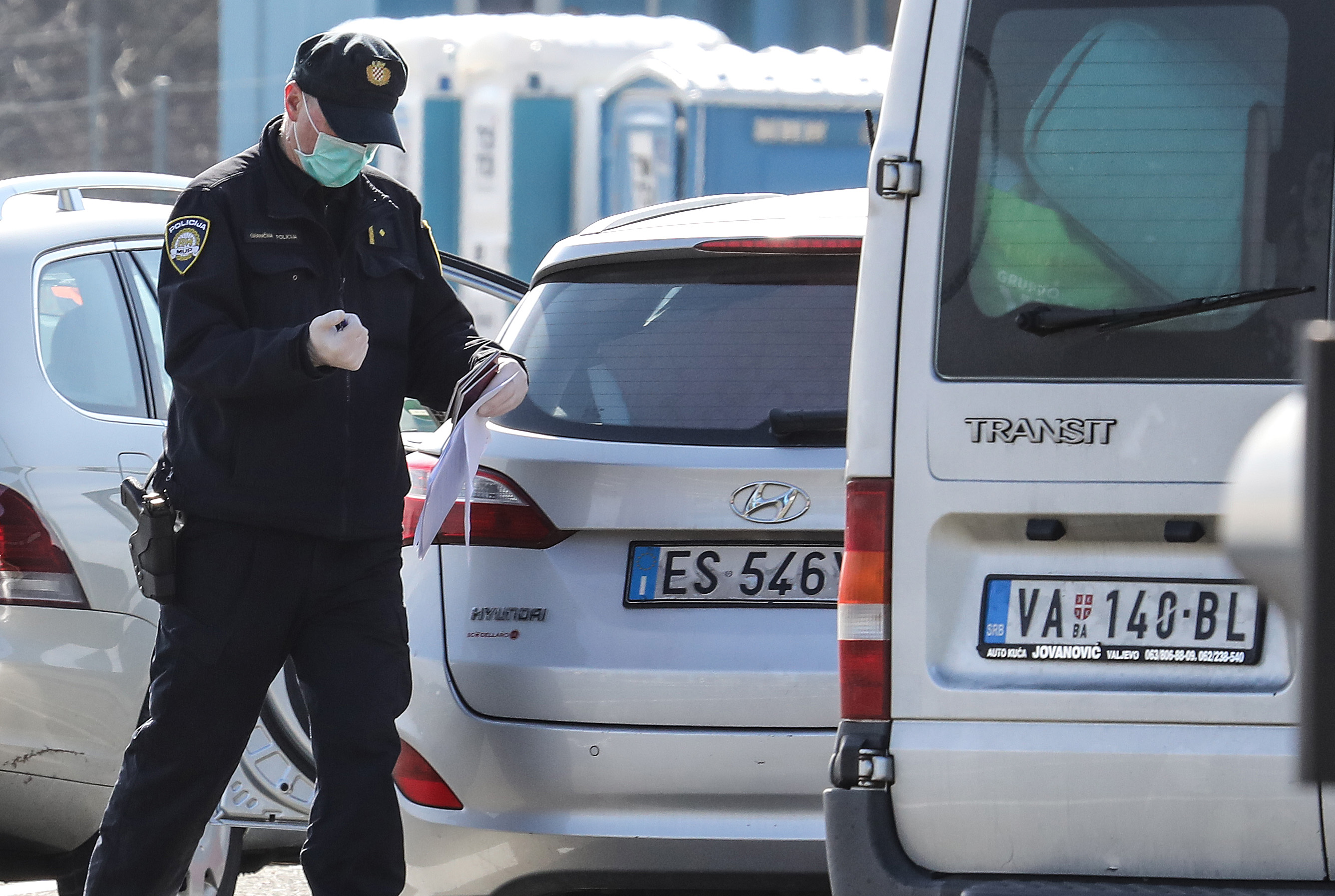 3月11日,在克罗地亚鲁帕与斯洛文尼亚交界的一处边境关口,一名警察戴