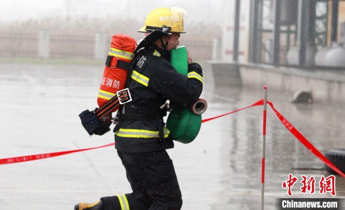 江苏扬州逾百名消防员冒雨比武提升综合应急救援能力
