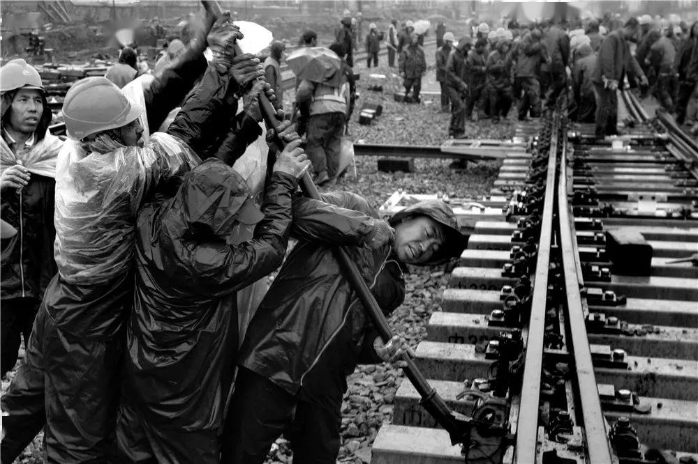 几吨重的轨道,在作业条件十分艰难的情况下,硬是靠人拉肩扛来完成.