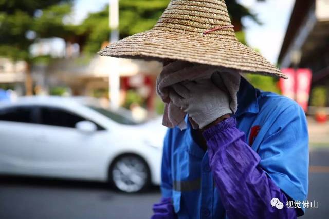 8月21日,禅城区天地路上,一位环卫工人正在用毛巾擦汗