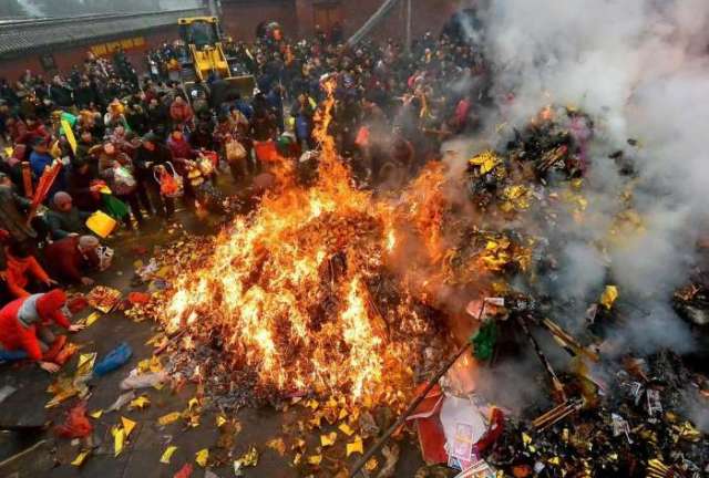 等到了焚烧祭祀的地点,人们纷纷将自己手中的祭品丢入祭祀的大火堆中