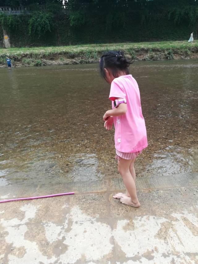 深圳龍崗河雨過天晴,可愛小女孩撈魚兒玩石頭