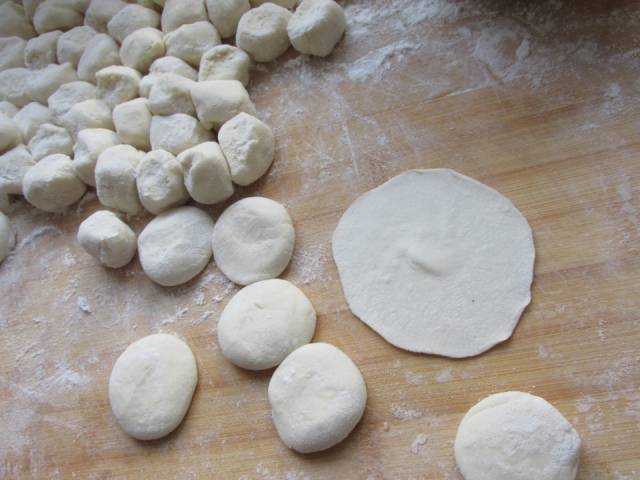 5,把面团揪成小剂子,擀成中间稍厚边上薄的饺子皮.