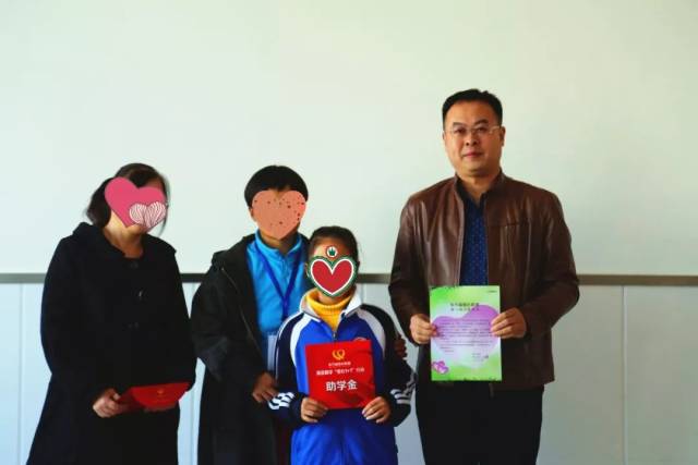 互生咨询总经理王昆与受助学子和家长合影