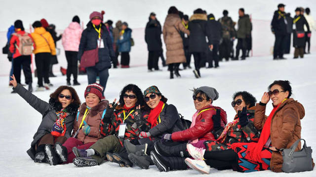 多种项目让游客在雪道上尽情嬉戏,集体出游的好友们摆出姿势在雪中