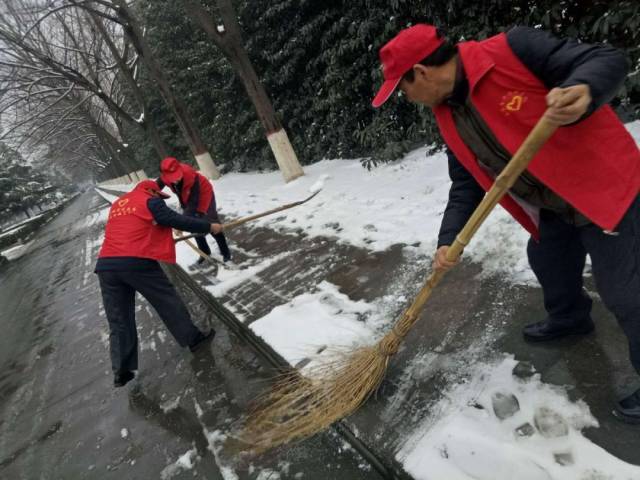 商务中心区管委志愿者在行政大厅西侧路段除冰扫雪