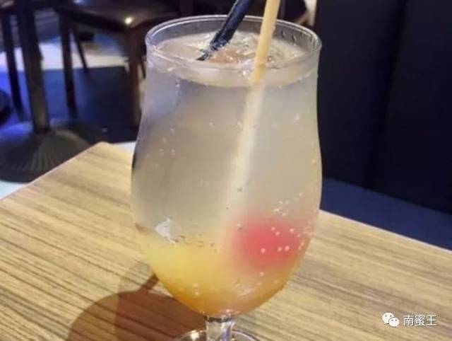 3, 冷冻蜜瓜碗取出,倒入苏打水冰块,放入冷藏果肉球,再淋上一点冷藏