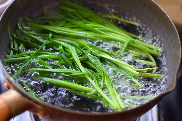 3,坐锅烧水,水开后把韭菜下锅煮一滚,煮好后捞出来.